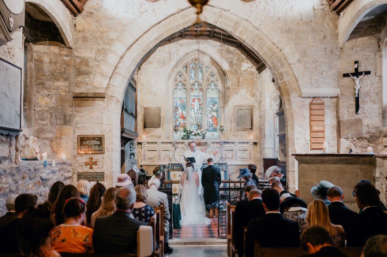 A church full of people as a couple get married